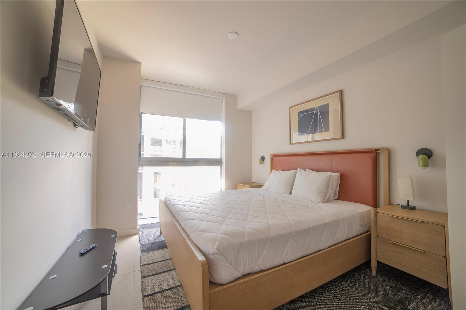 11 Northeast 6th Street, Unit 1403 Miami, FL 33132 - Photo 10 of 44 a bedroom with a bed and a flat screen tv