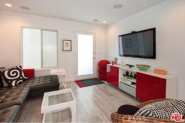 a bedroom with furniture and a wooden floor