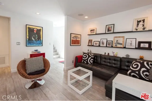 a living room with furniture a couch and painting on the wall