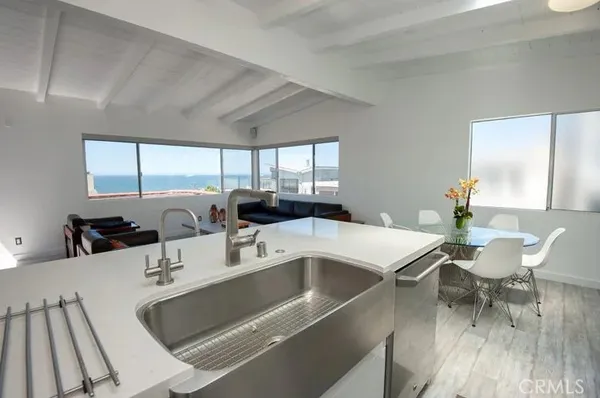 a room with a white table chairs and a dining table with wooden floor