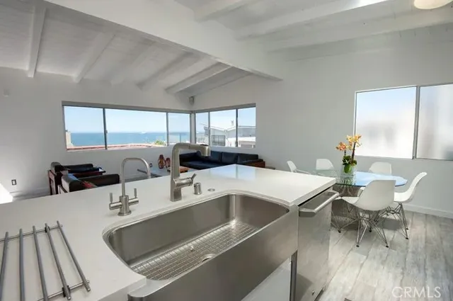 a room with a white table chairs and a dining table with wooden floor