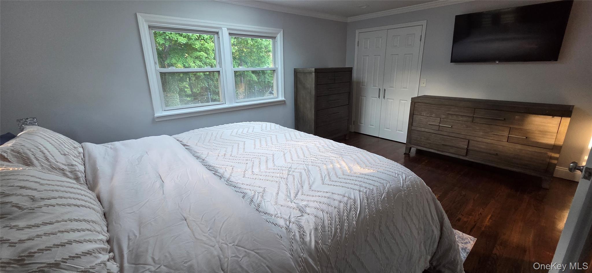 522 Moriches Road St. James, NY 11780 - Photo 34 of 49 a bedroom with a bed tv and a window