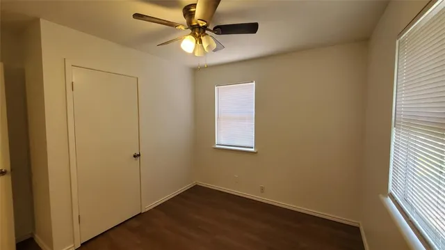 an empty room with a fan and a ceiling fan