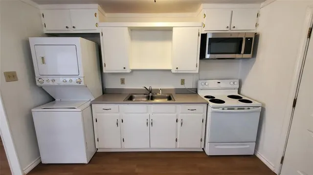 a kitchen with sink cabinets and wooden floor