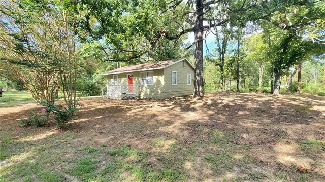 a view of a house with a tree in the yard