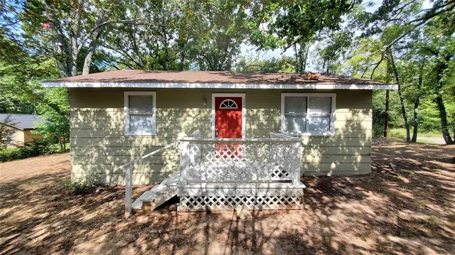 a view of a house with a tree in the background