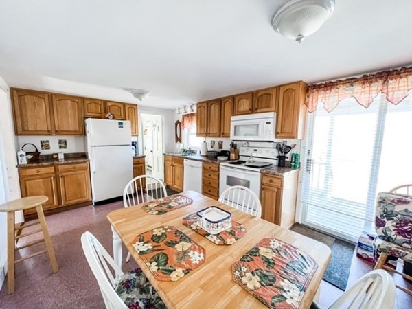 849 State Road, Unit 1 Aquinnah, MA 02535 - Photo 2 of 8 a kitchen with a refrigerator and a stove top oven