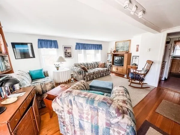 a view of a livingroom with furniture and a flat screen tv