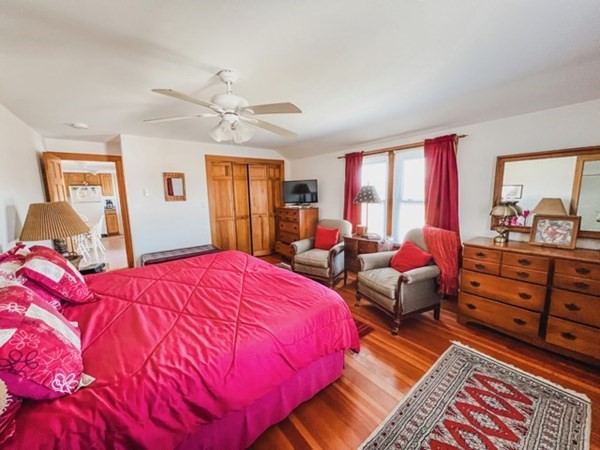 849 State Road, Unit 1 Aquinnah, MA 02535 - Photo 8 of 8 a bedroom with a bed and a dresser