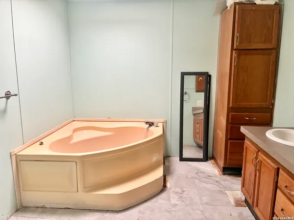 a bathroom with a tub and shower