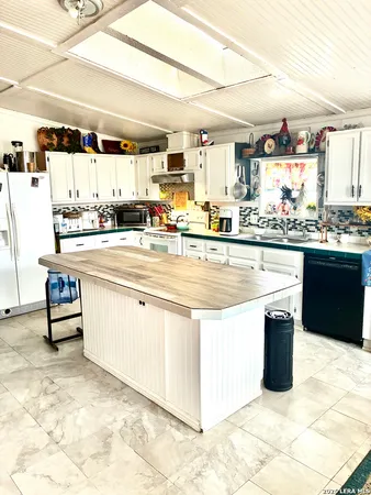 a kitchen with stainless steel appliances kitchen island granite countertop a sink and cabinets