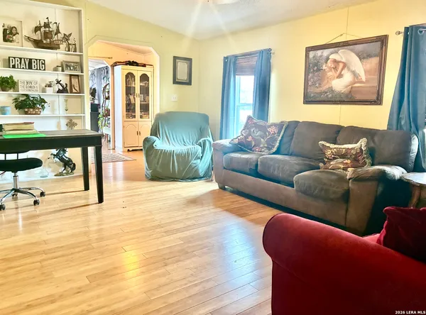 a living room with furniture and a painting on the wall
