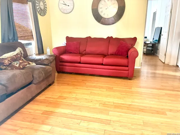 a living room with couch and a mirror