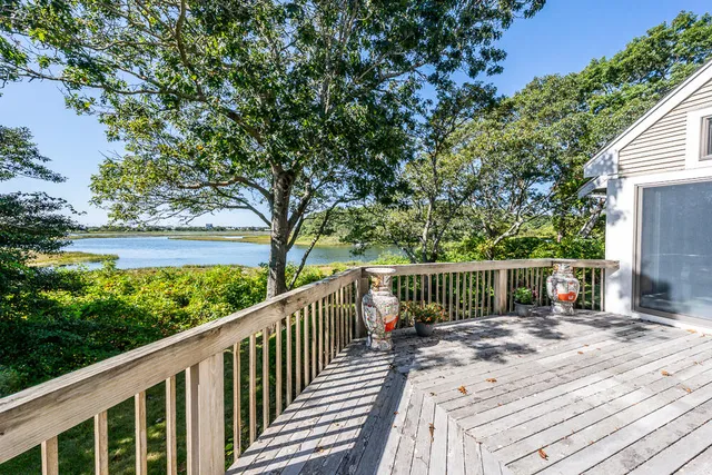 a view of balcony with wooden floor and fence
