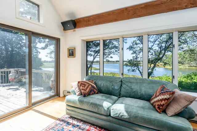 a living room with couch and a large window