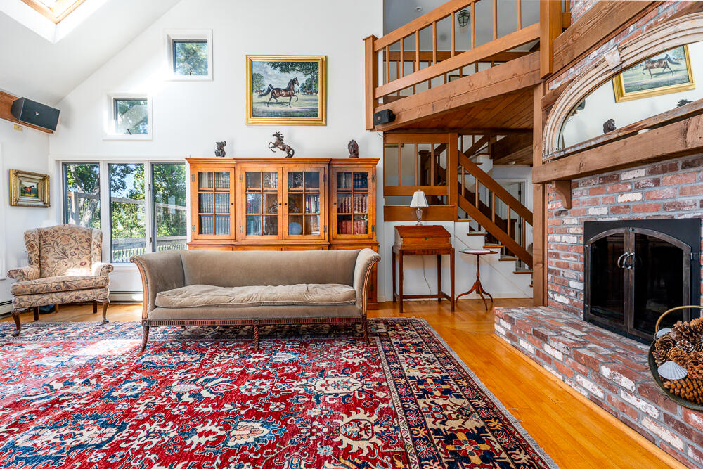 498 Elliott Road Centerville, MA 02632 - Photo 12 of 32 a living room with furniture and a fireplace