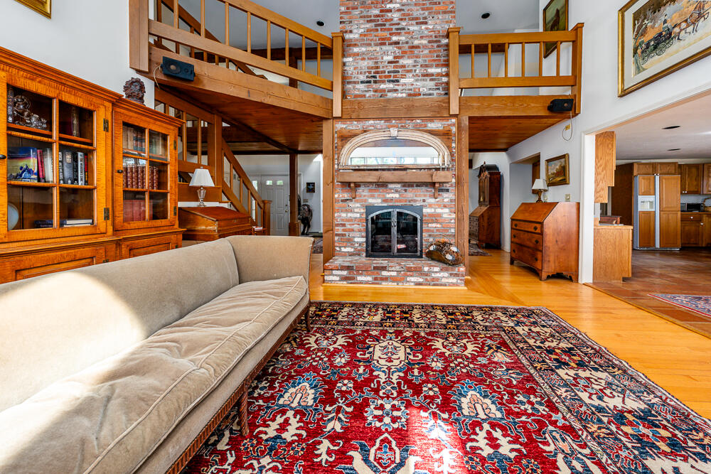 498 Elliott Road Centerville, MA 02632 - Photo 13 of 32 a living room with fireplace furniture and a rug