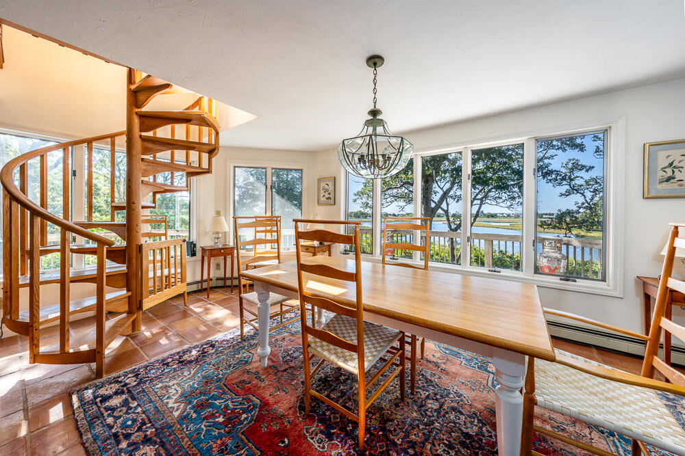 498 Elliott Road Centerville, MA 02632 - Photo 15 of 32 a view of a livingroom with furniture wooden floor and a floor to ceiling window