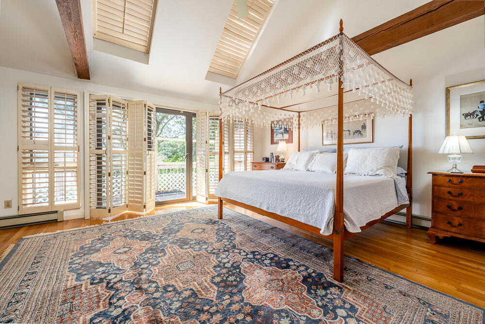 498 Elliott Road Centerville, MA 02632 - Photo 18 of 32 a bedroom with a bed next to a large window with the outer view