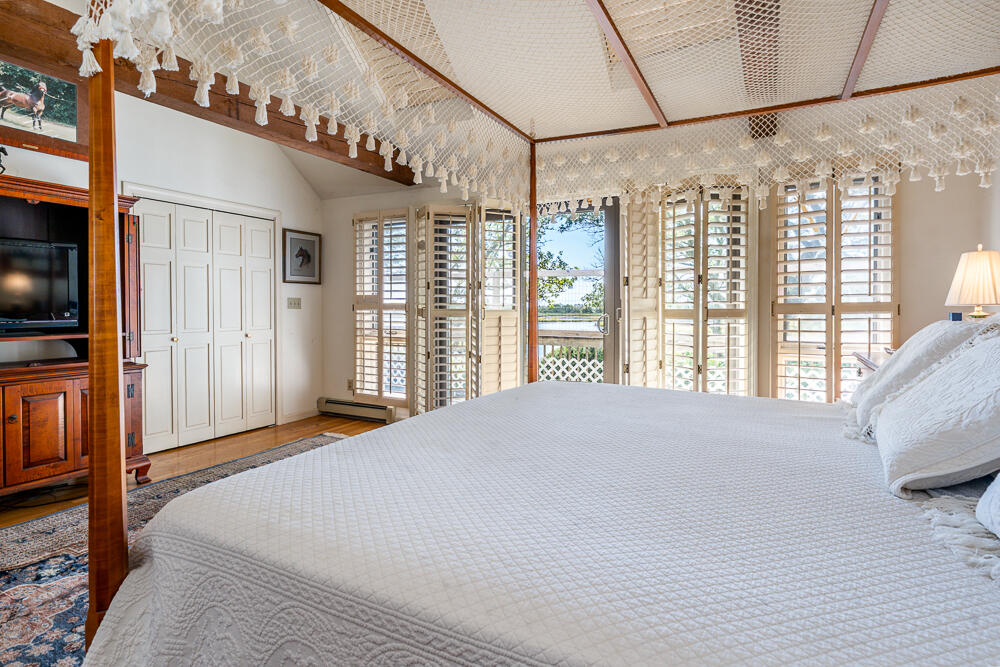 498 Elliott Road Centerville, MA 02632 - Photo 19 of 32 a bedroom with a large bed and a large window