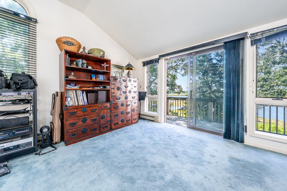 498 Elliott Road Centerville, MA 02632 - Photo 28 of 32 a view of an empty room with furniture and a large window