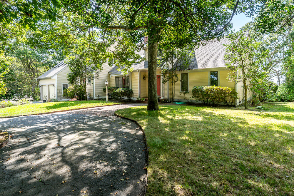 498 Elliott Road Centerville, MA 02632 - Photo 5 of 32 a view of a house with a big yard and large trees