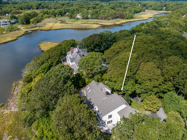 an aerial view of ocean residential house with outdoor space and swimming pool