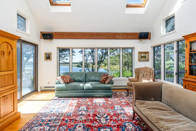 a living room with furniture and a floor to ceiling window