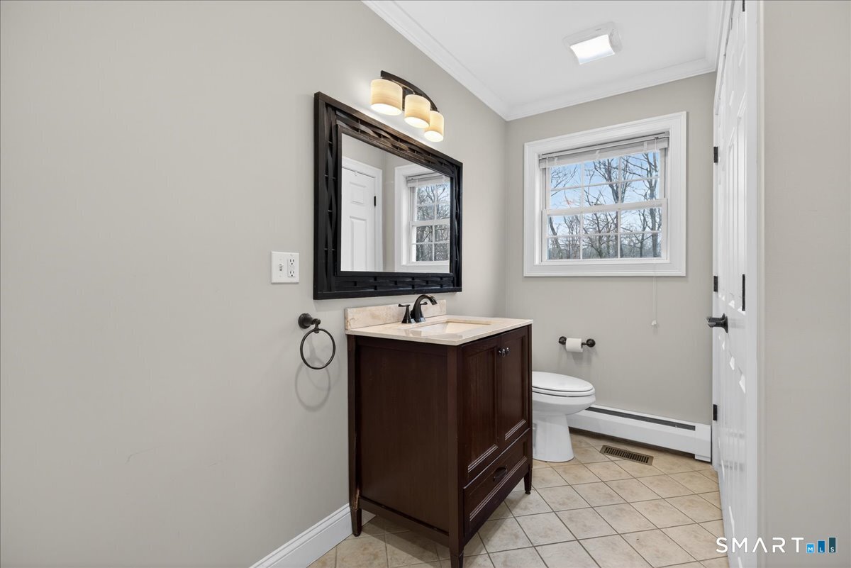 22 Emerald Lane Bethany, CT 06524 - Photo 11 of 28 a bathroom with a toilet sink and mirror