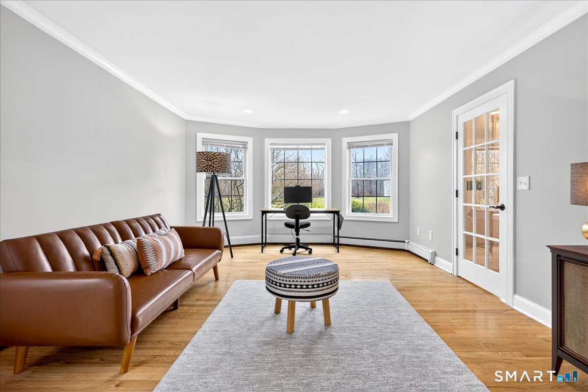 22 Emerald Lane Bethany, CT 06524 - Photo 12 of 28 a living room with furniture a rug and a table