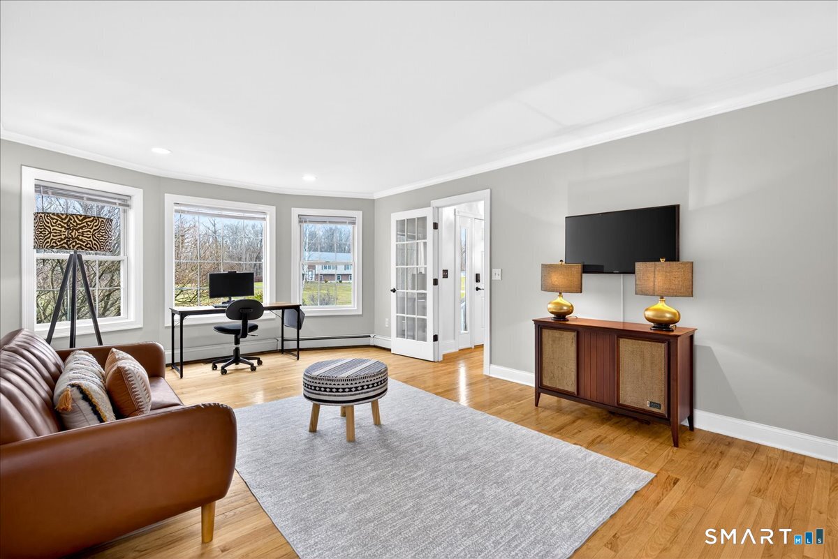 22 Emerald Lane Bethany, CT 06524 - Photo 13 of 28 a living room with furniture and a flat screen tv