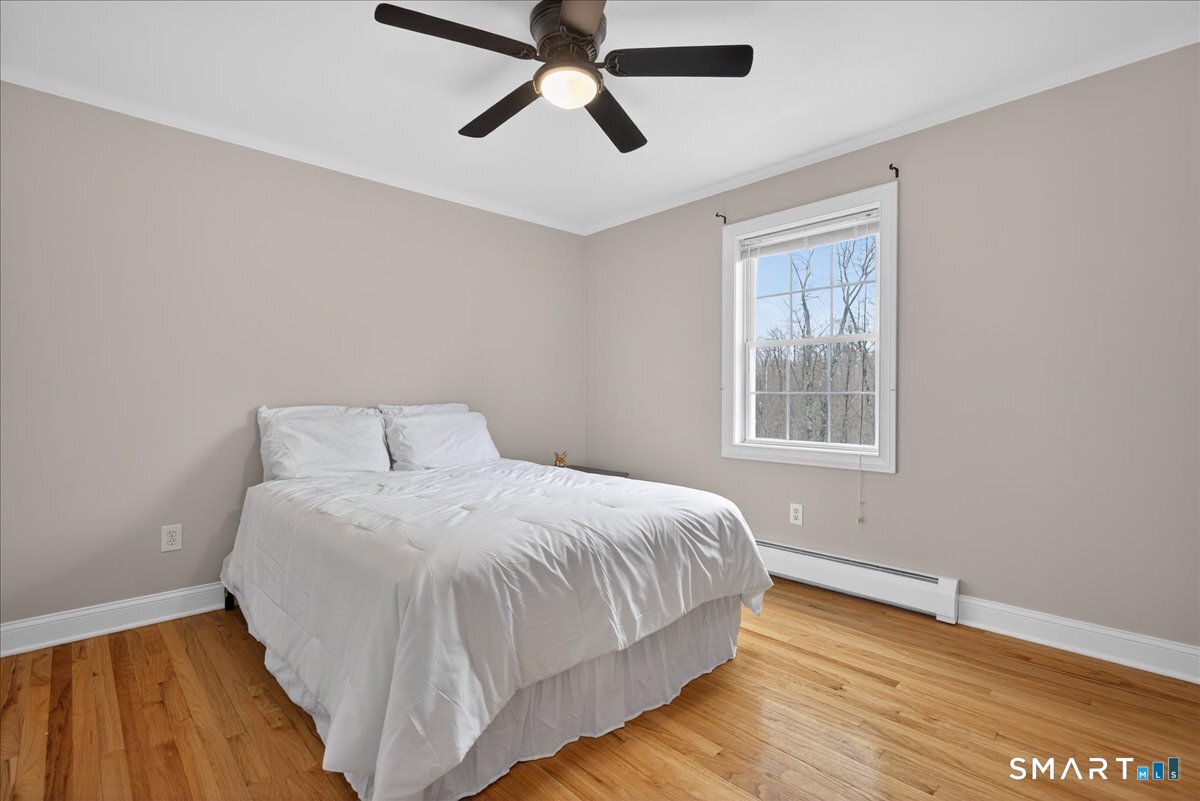 22 Emerald Lane Bethany, CT 06524 - Photo 14 of 28 a bedroom with a bed and wooden floor
