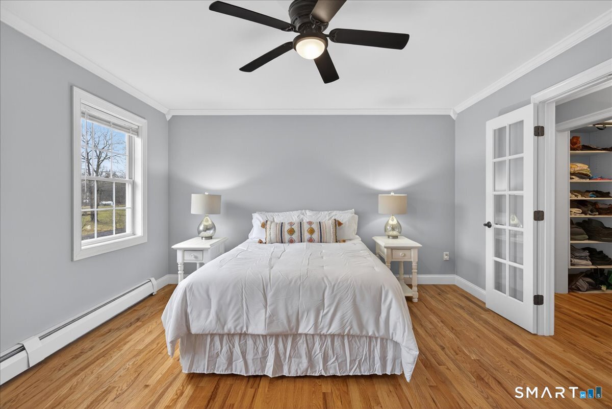 22 Emerald Lane Bethany, CT 06524 - Photo 18 of 28 a bedroom with a bed and dresser with wooden floor