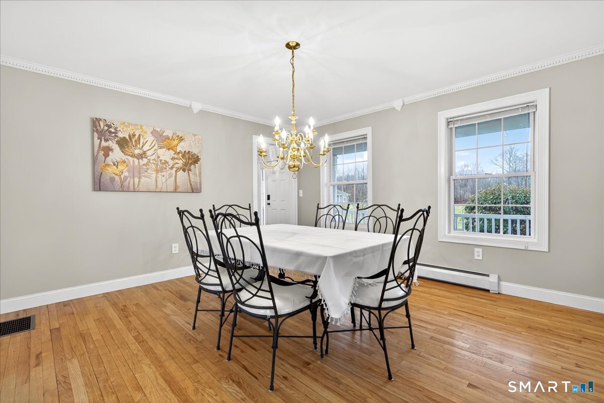 22 Emerald Lane Bethany, CT 06524 - Photo 4 of 28 a view of a dining room with furniture window and wooden floor