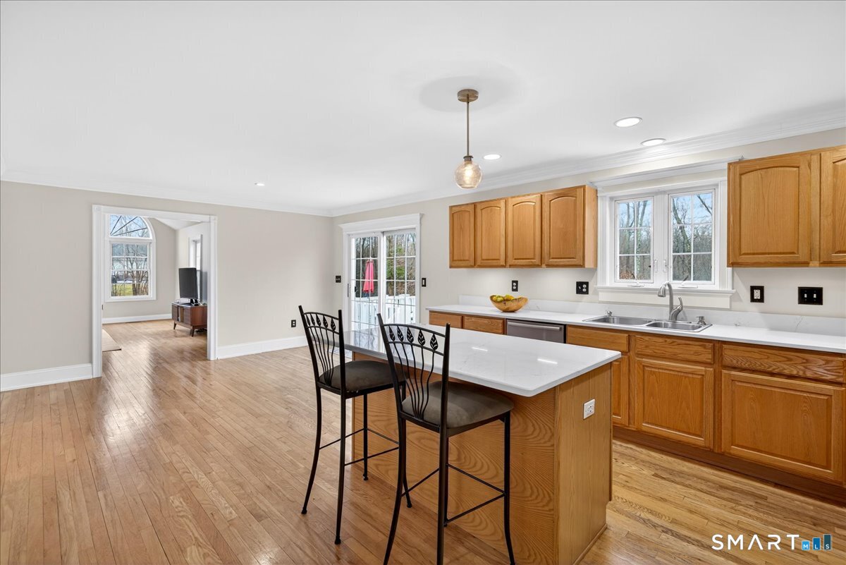 22 Emerald Lane Bethany, CT 06524 - Photo 9 of 28 a kitchen with stainless steel appliances granite countertop wooden floor window and cabinets