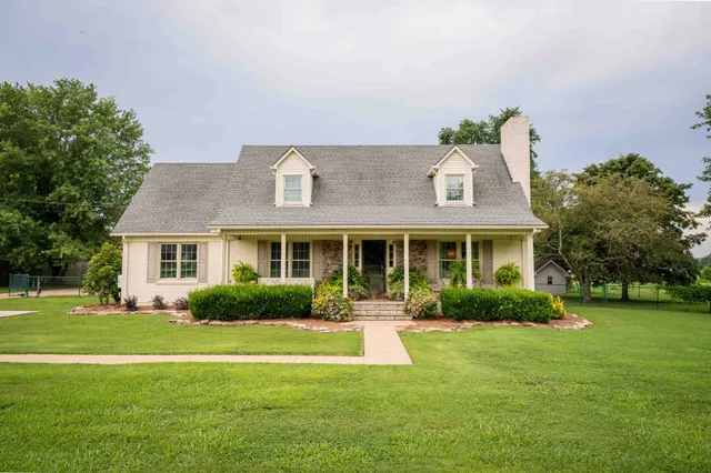 a front view of house with yard and green space