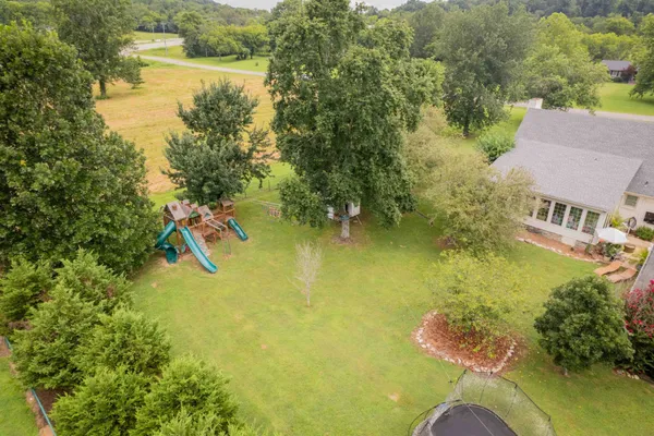 an aerial view of residential house with outdoor space and swimming pool