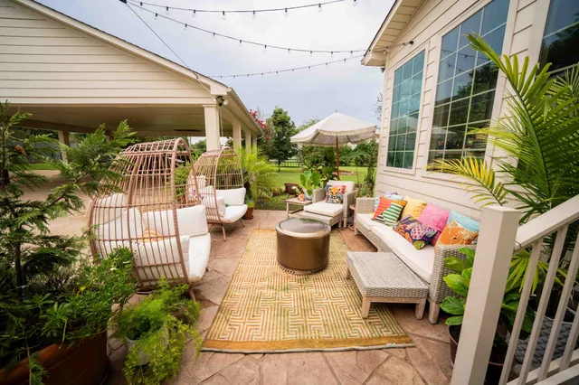 a view of a patio with table and chairs potted plants