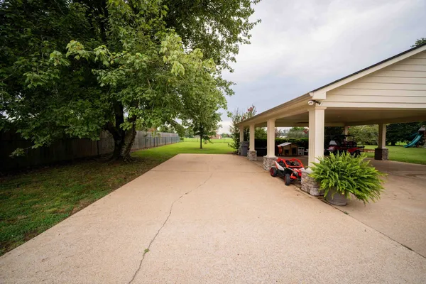 a living room with furniture chandelier and large windows
