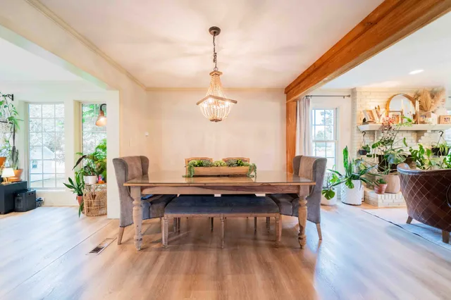 a living room with furniture a large window and a table