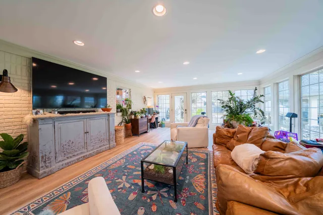 a living room filled with furniture and a large window