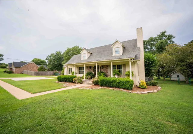 a front view of a house with a yard table and chairs