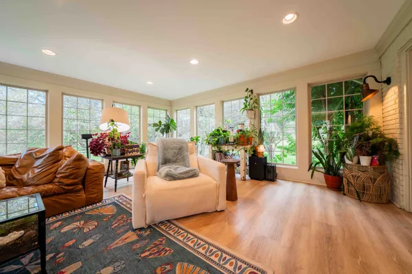 a kitchen with a sink a stove cabinets dining table and chairs