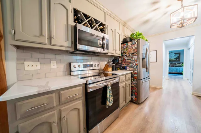 a bedroom with a bed wooden floor and a rug