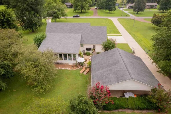 an aerial view of a house with a big yard