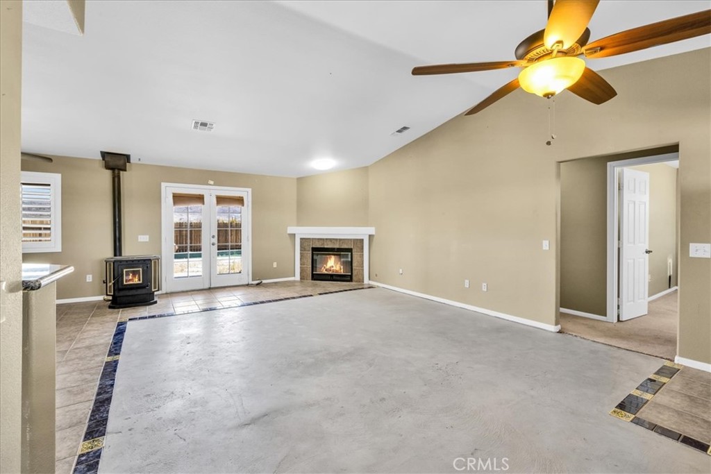 63357 Uranium Road Joshua Tree, CA 92252 - Photo 11 of 54 a view of an empty room with a fireplace and a window