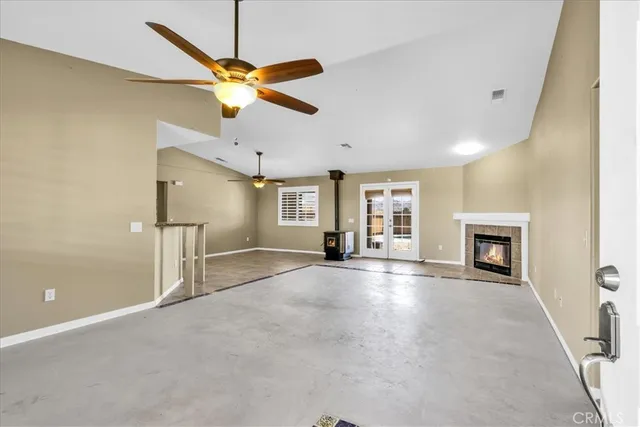 a view of a livingroom with a fireplace and a ceiling fan