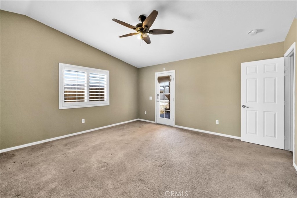 63357 Uranium Road Joshua Tree, CA 92252 - Photo 15 of 54 an empty room with ceiling fan and windows