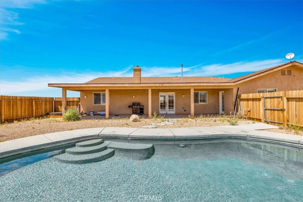 63357 Uranium Road Joshua Tree, CA 92252 - Photo 30 of 54 a view of a house with swimming pool and sitting area