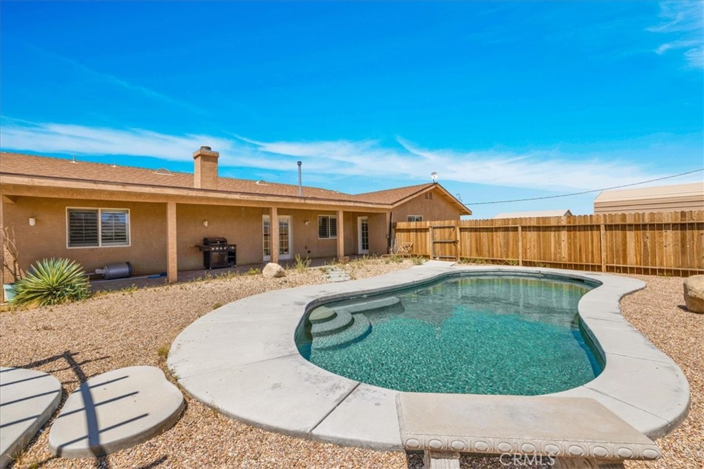 63357 Uranium Road Joshua Tree, CA 92252 - Photo 31 of 54 a view of a house with a swimming pool